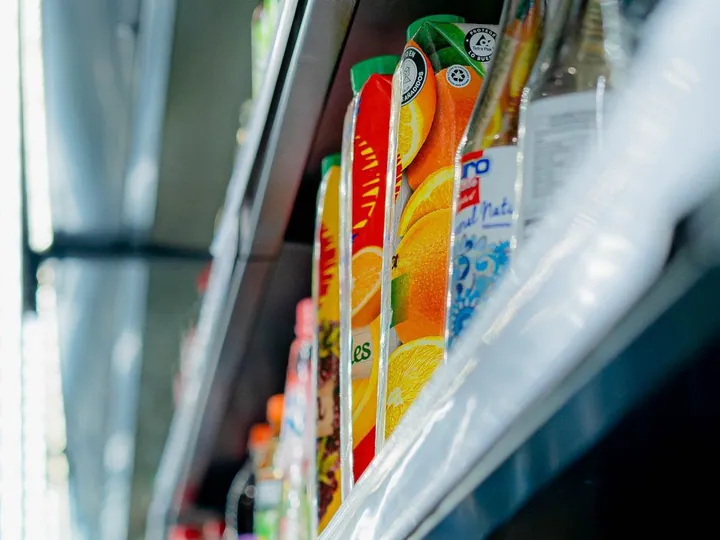 Assorted bottled drinks in a store cooler