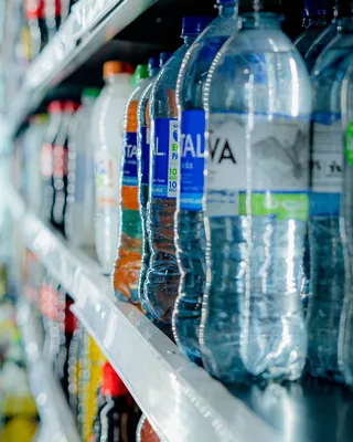 Assorted bottled drinks in a store cooler