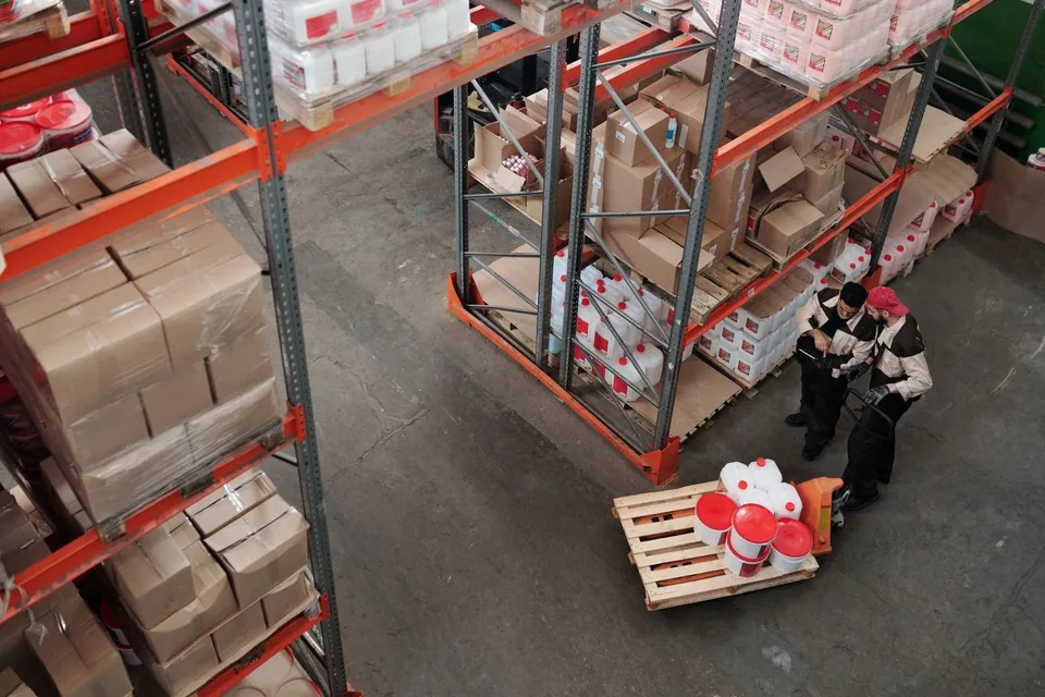 Workers checking shelves in a warehouse